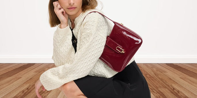 A woman wearing a preppy outfit with a preppy purse