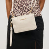 Woman wearing Ivory Urban Expressions Nightingale Wristlet 840611194541 View 1 | Ivory