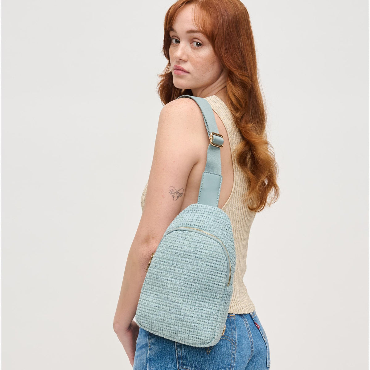 Woman wearing Blue Urban Expressions Jean Sling Backpack 840611146540 View 1 | Blue